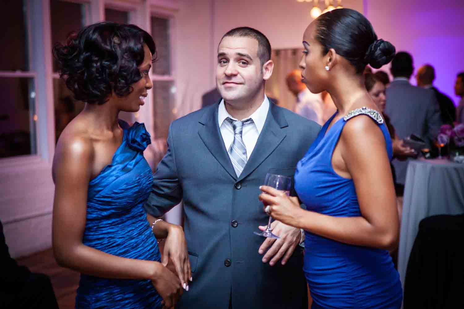 Male guest flanked by two female guests at an Attic Studios wedding