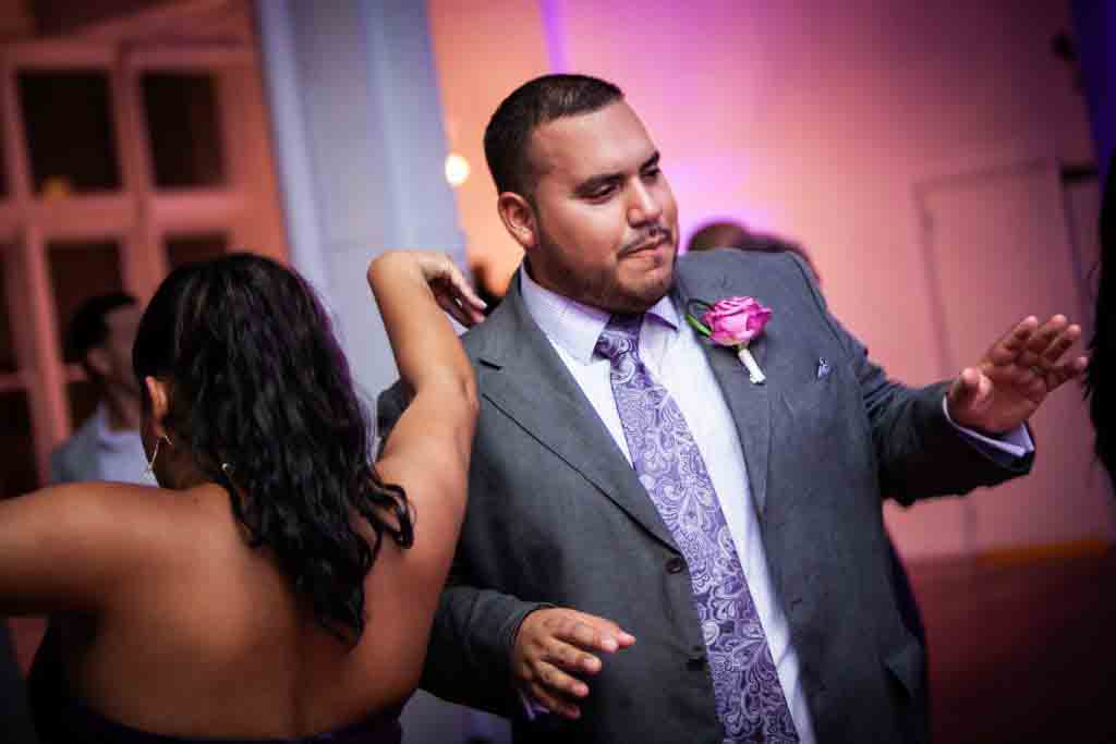 Groom dancing with guest at an Attic Studios wedding