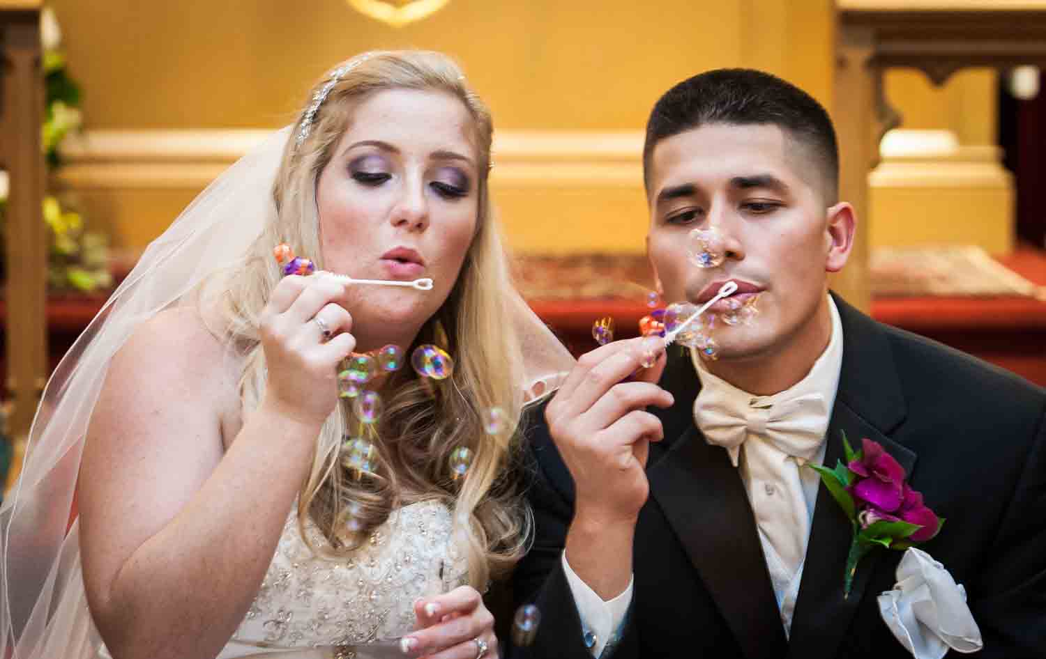 Bride and groom blowing bubbles