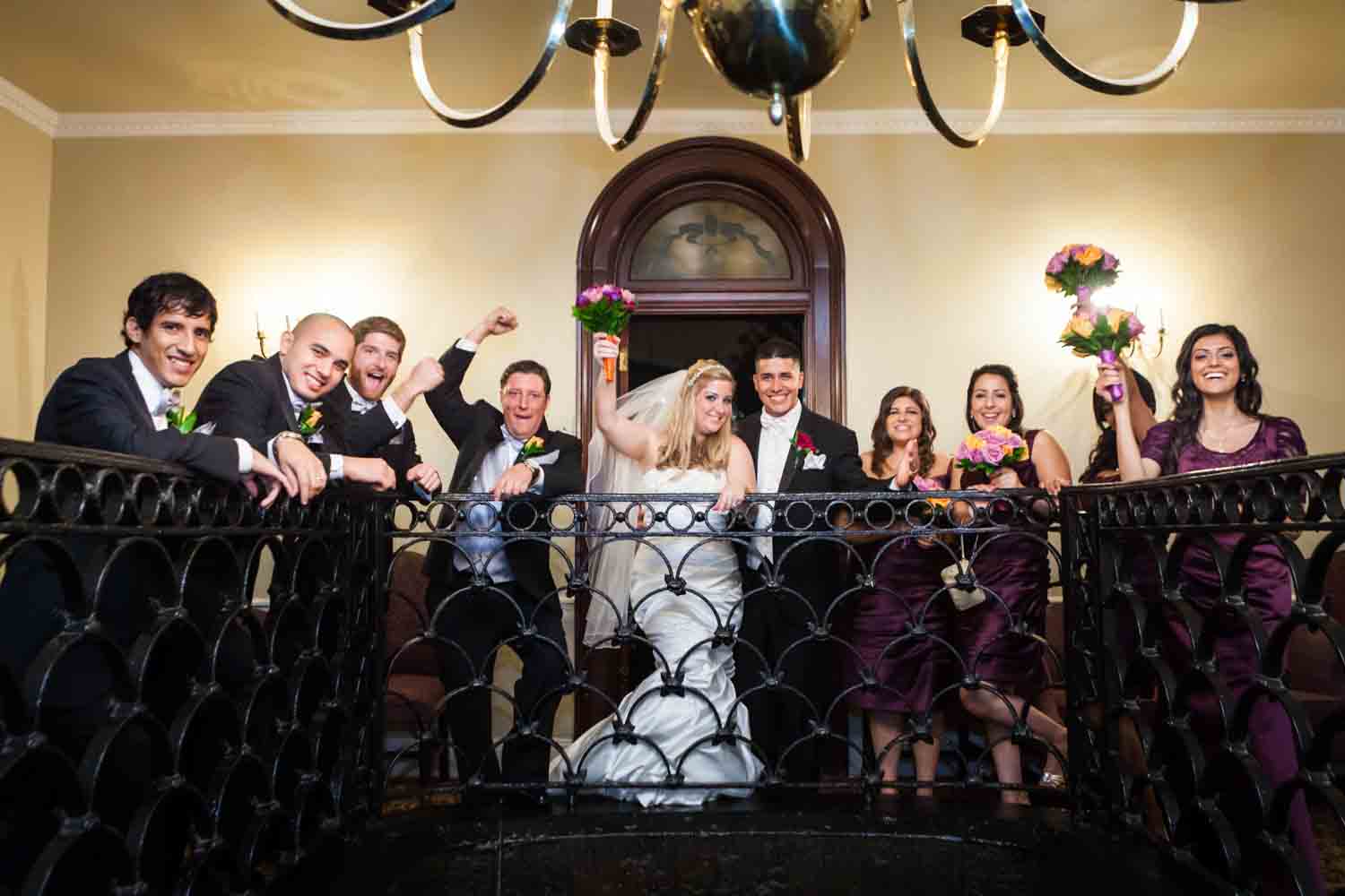 Bridal party cheering in stairwell of Fort Hamilton Community Club