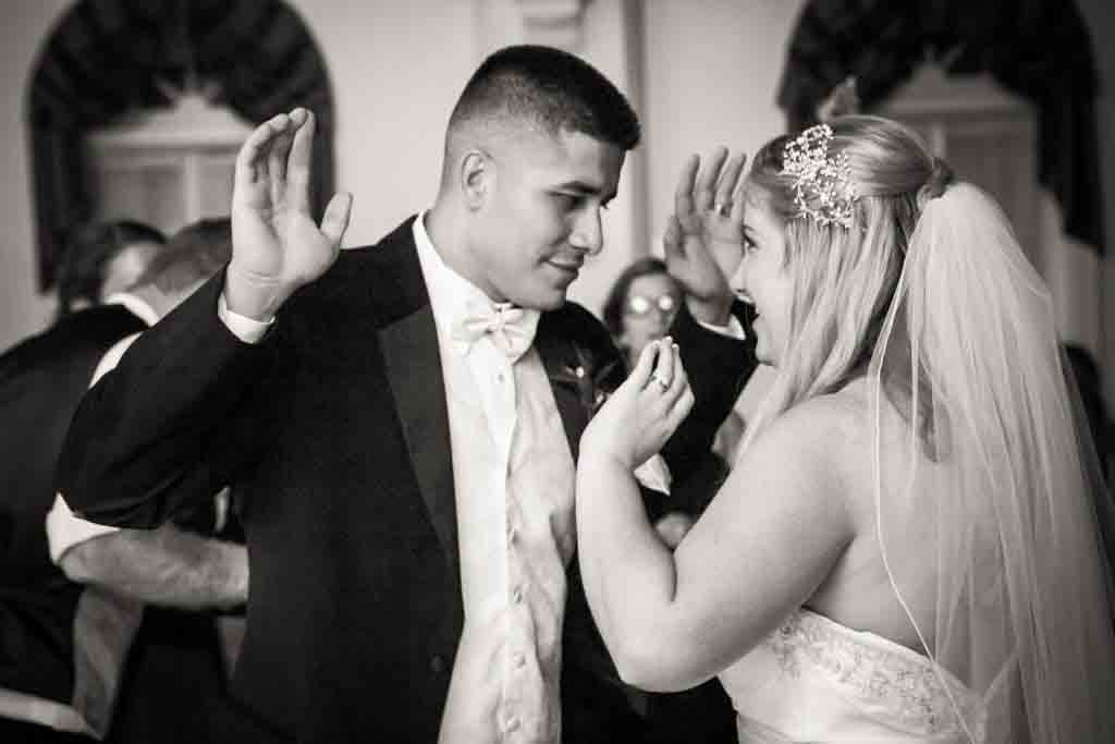 Black and white photo of bride and groom dancing at a Fort Hamilton Community Center wedding