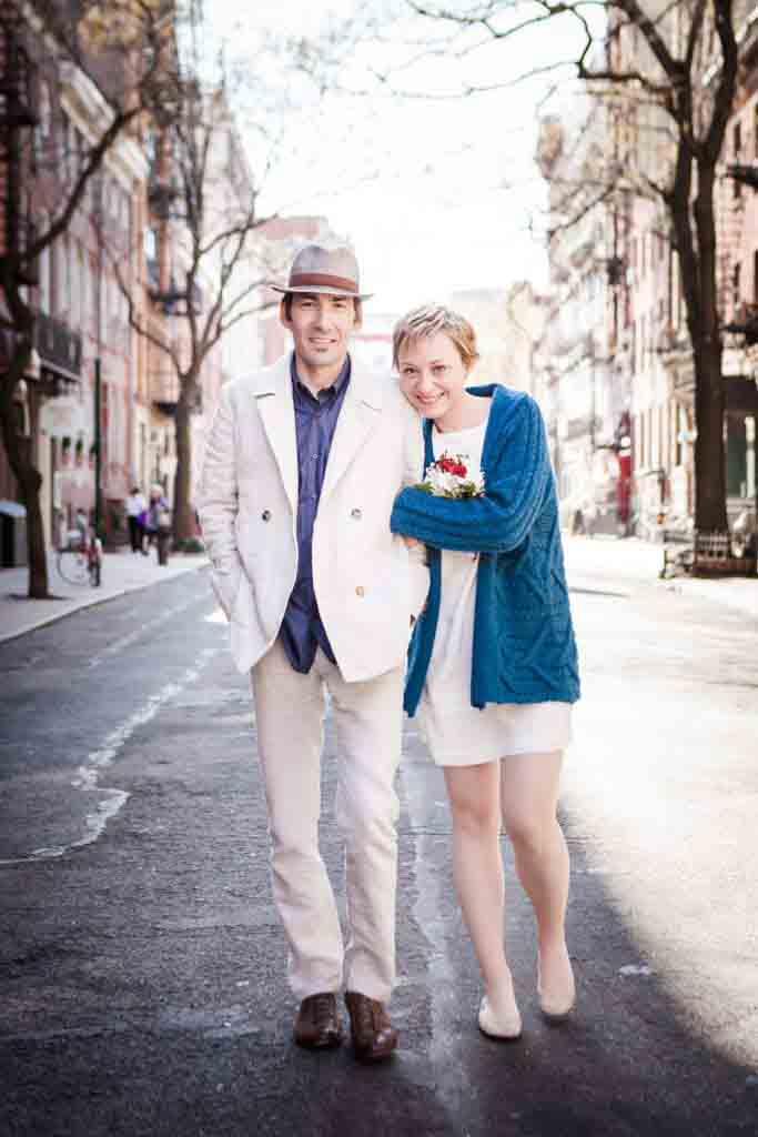 Washington Square Park portrait of man and woman walking down a NYC street as in Bob Dylan album cover