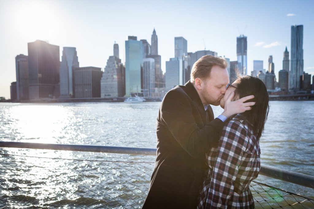 Couple kissing in front of East River