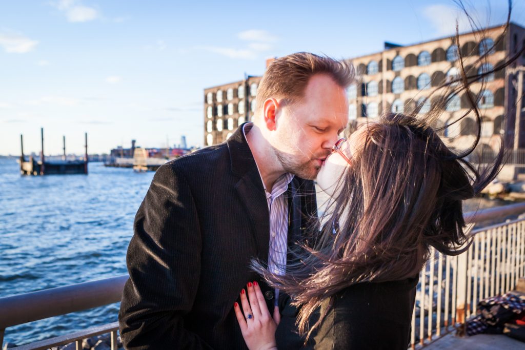 Red Hook engagement photos of couple kissing in front of East River