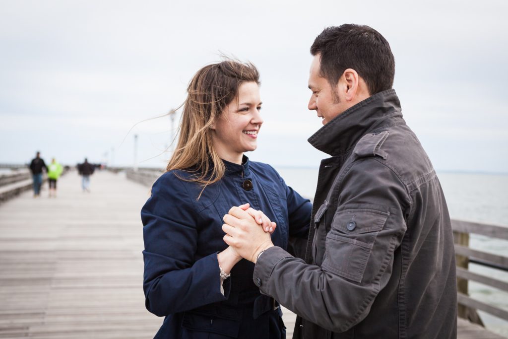 Couple dancing on Coney Island pier boardwalk