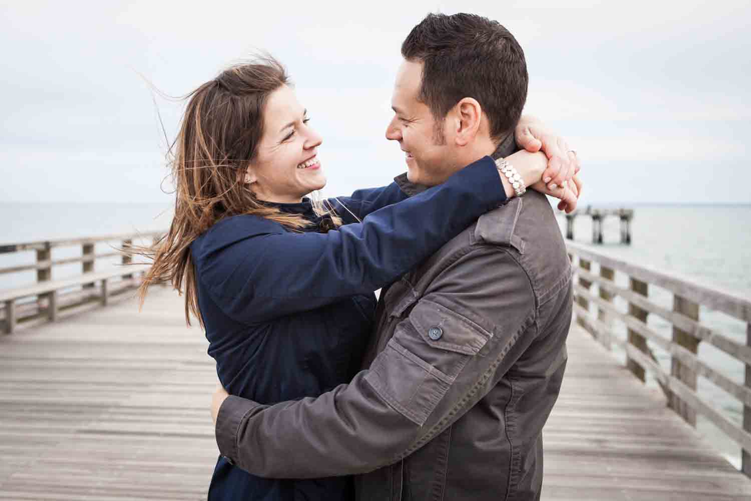Couple hugging on Coney Island pier boardwalk