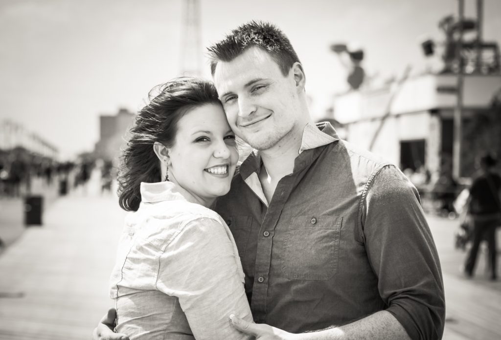 Black and white photo of couple on boardwalk