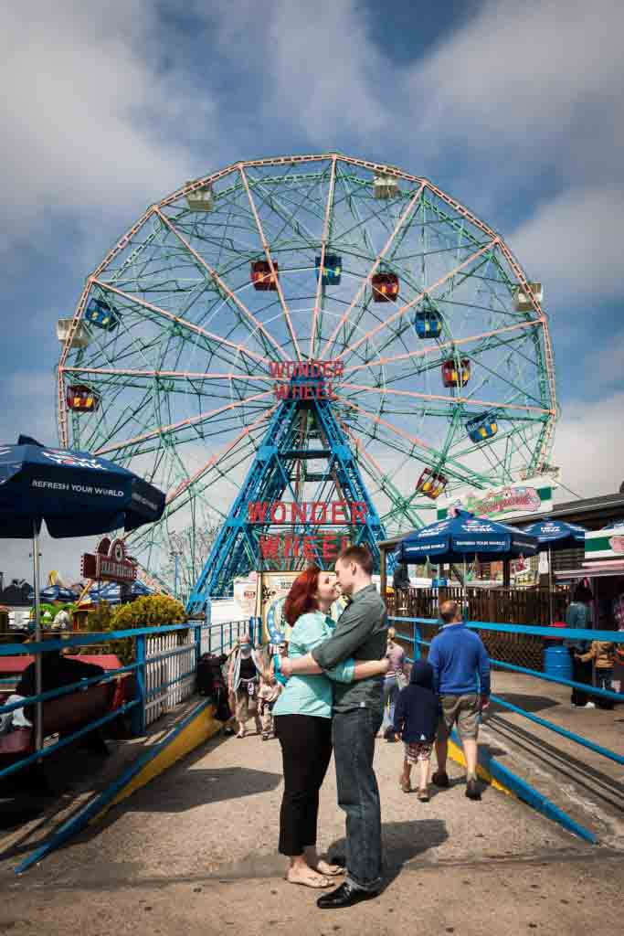 Coney Island engagement photos of couple in front of Wonder Wheel