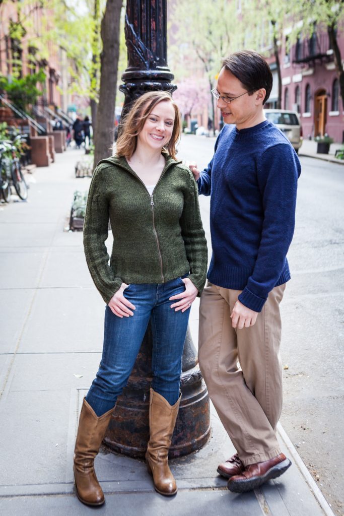 Couple leaning against light post in Greenwich Village