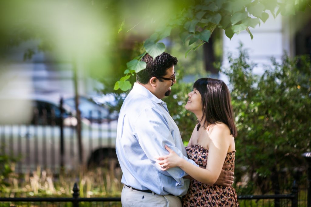 View through branches of couple in Madison Square Park