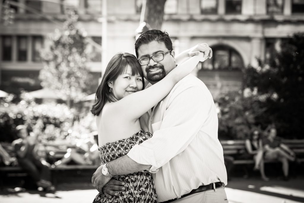 Black and white photo of couple hugging in Madison Square Park