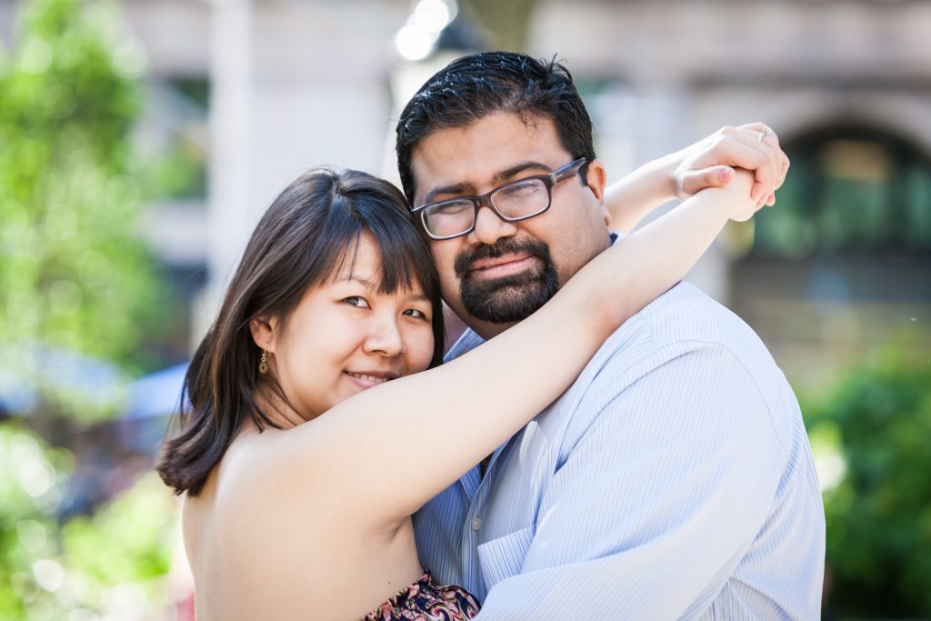 Couple hugging during a Madison Square Park engagement session