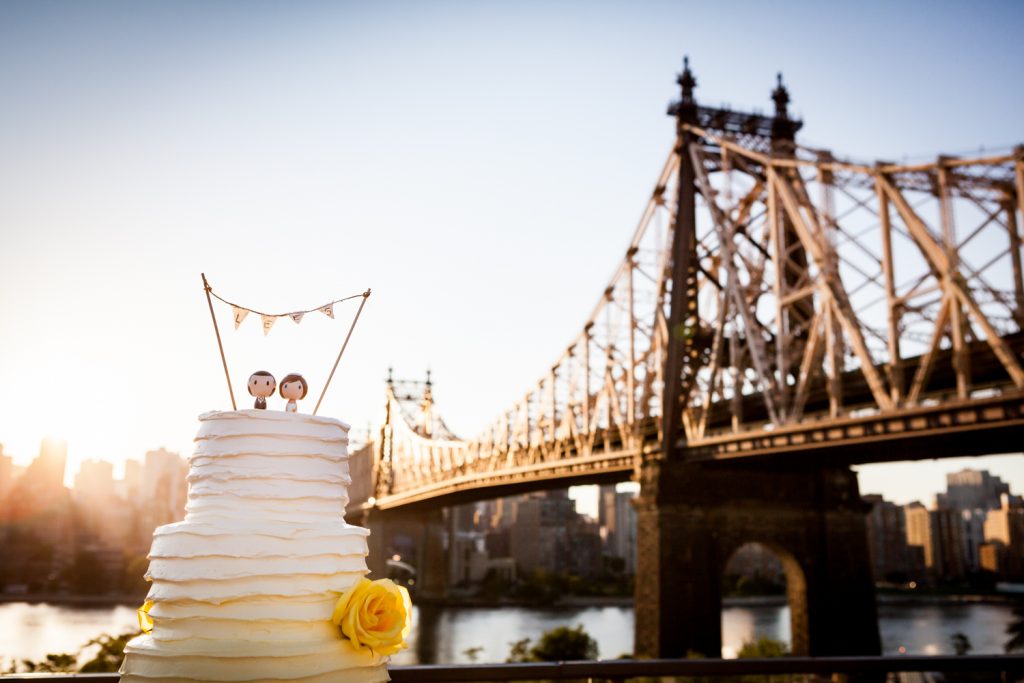 Wedding cake with Queensborough Bridge in background for a Ravel Hotel Penthouse wedding