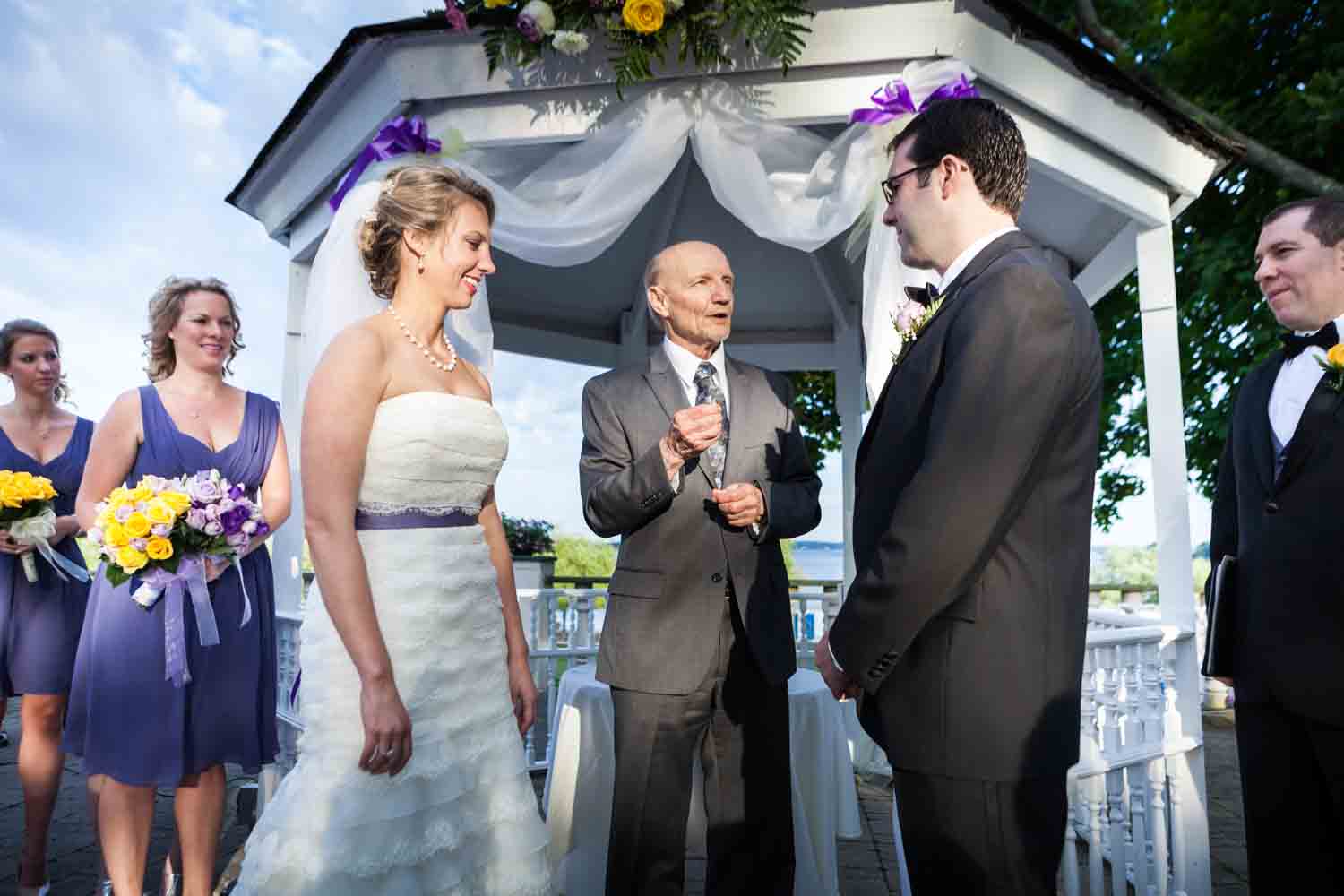 Officiant speaking to bride and groom at a Davenport Mansion wedding