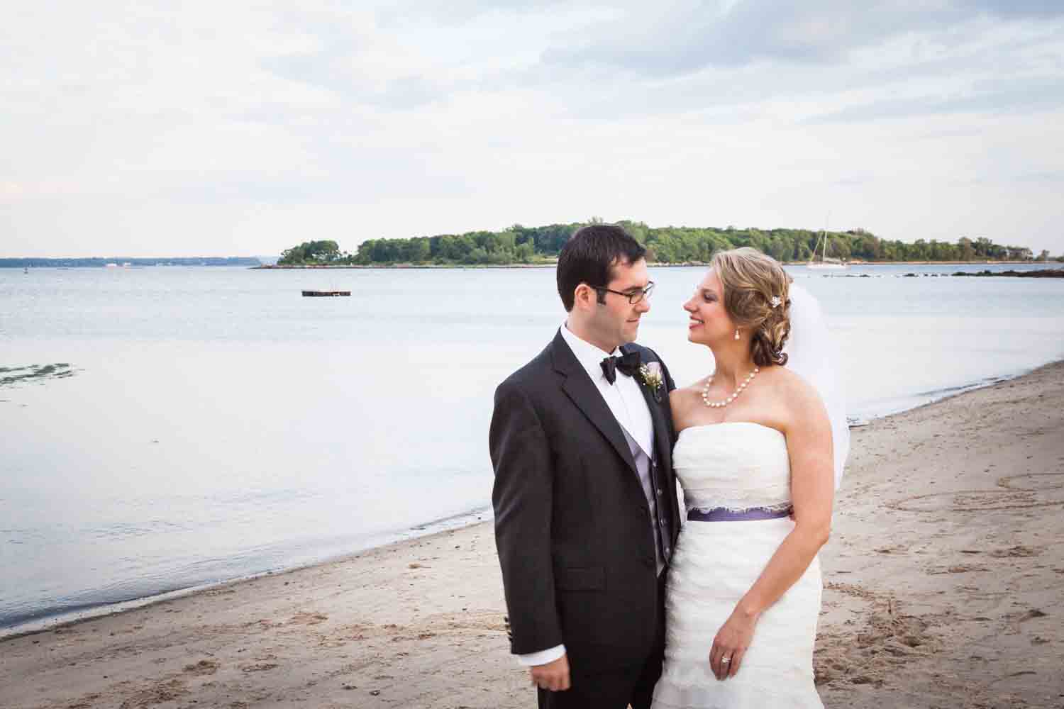 Bride and groom on beach at a Davenport Mansion wedding