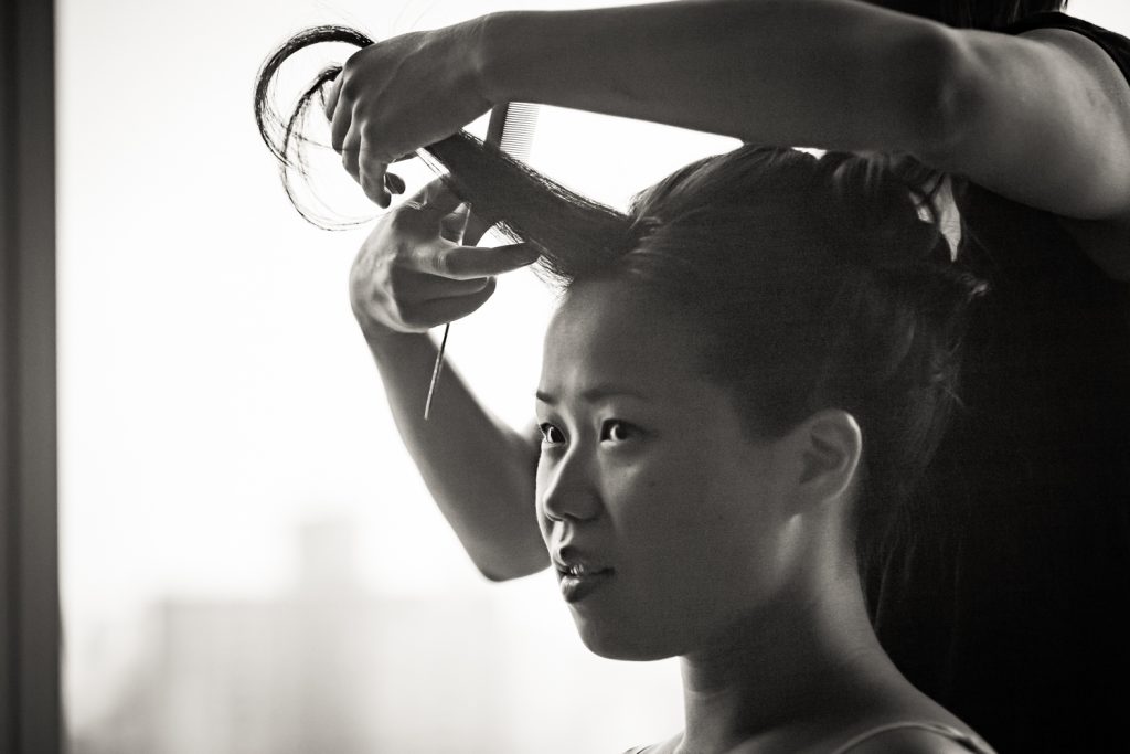 Black and white photo of bride getting hair curled