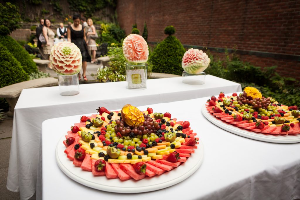 Plates of intricately carved fruit at a Merchant's House Museum wedding