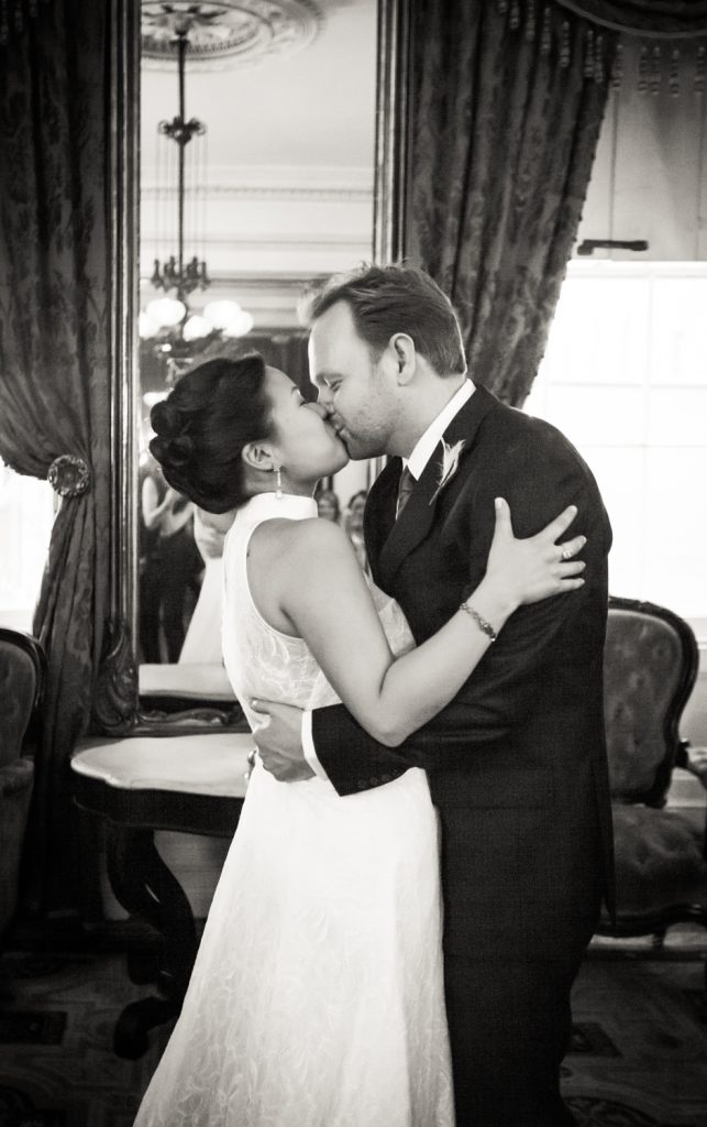 Black and white photo of bride and groom kissing at a Merchant's House Museum wedding
