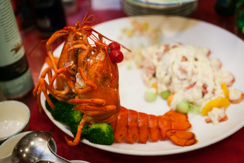 Close up on two lobsters on a plate at a Congee Village wedding reception