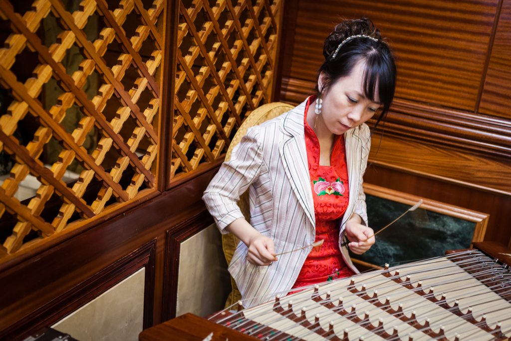 Woman playing musical instrument at a Congee Village wedding reception