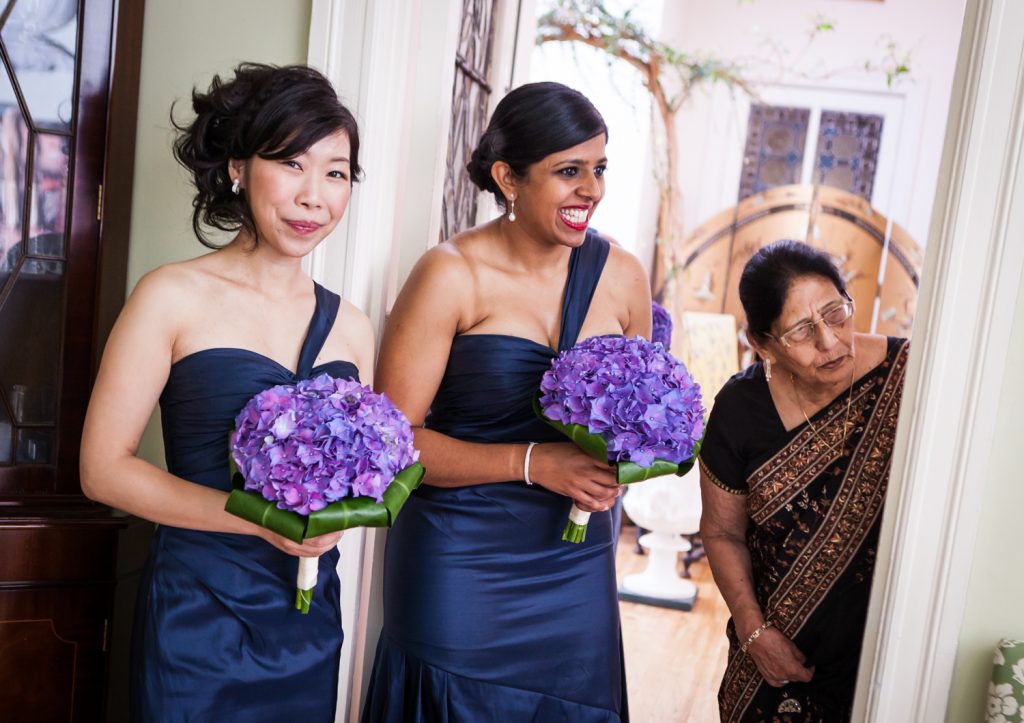 Bridesmaids and mother of groom looking in from doorway at an Alger House wedding