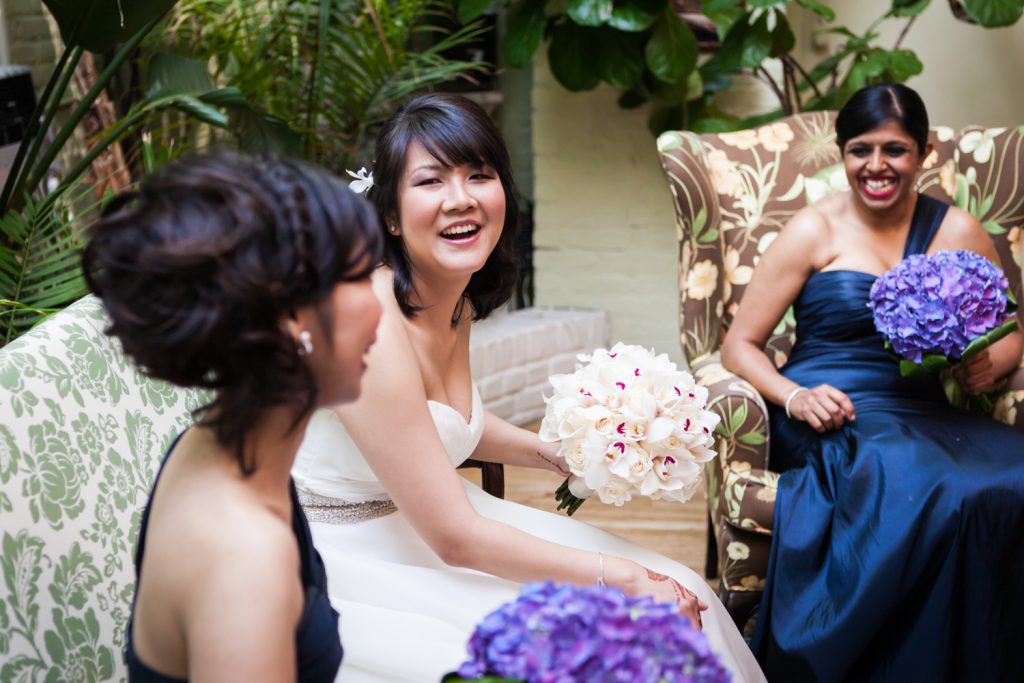 Bride in white dress laughing with bridesmaids at an Alger House wedding