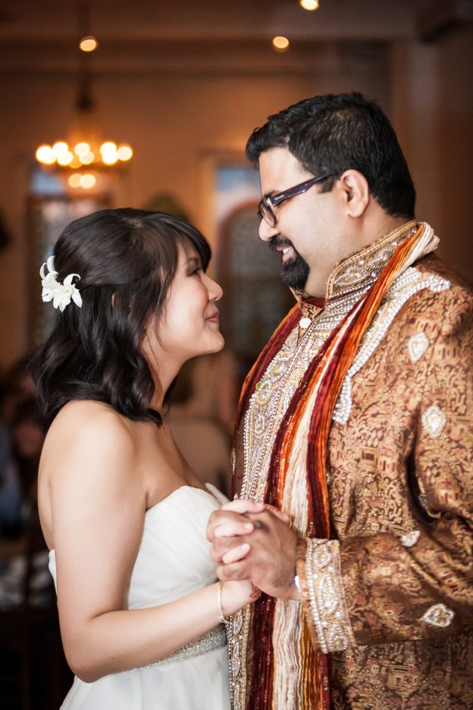 Bride and groom wearing traditional Indian attire during first dance at an Alger House wedding
