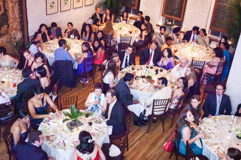 Wide shot of guests sitting at tables at an Alger House wedding