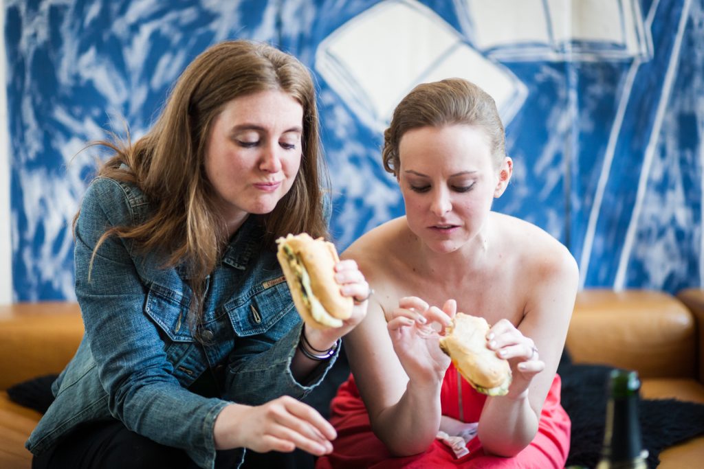 Two women eating sandwiches