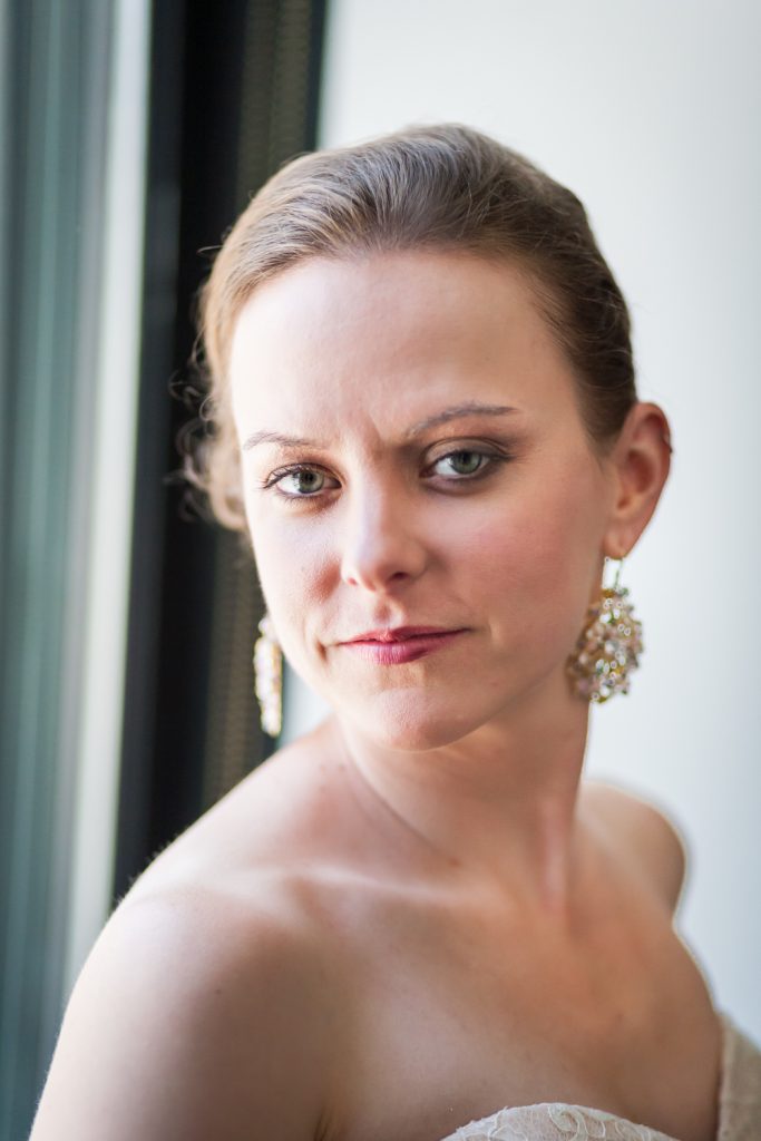 Portrait of bride wearing sparkly earrings at a Brooklyn Bridge Park wedding