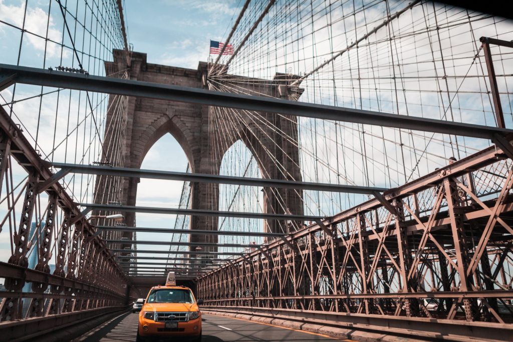 Taxi cab driving across Brooklyn Bridge