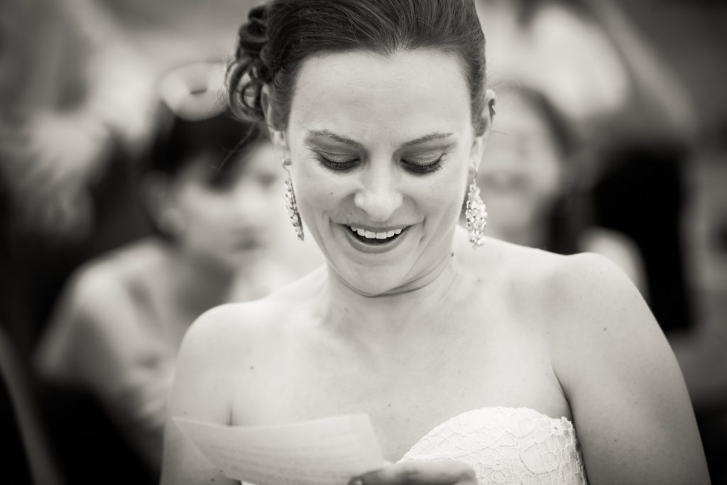 Black and white photo of bride saying vows