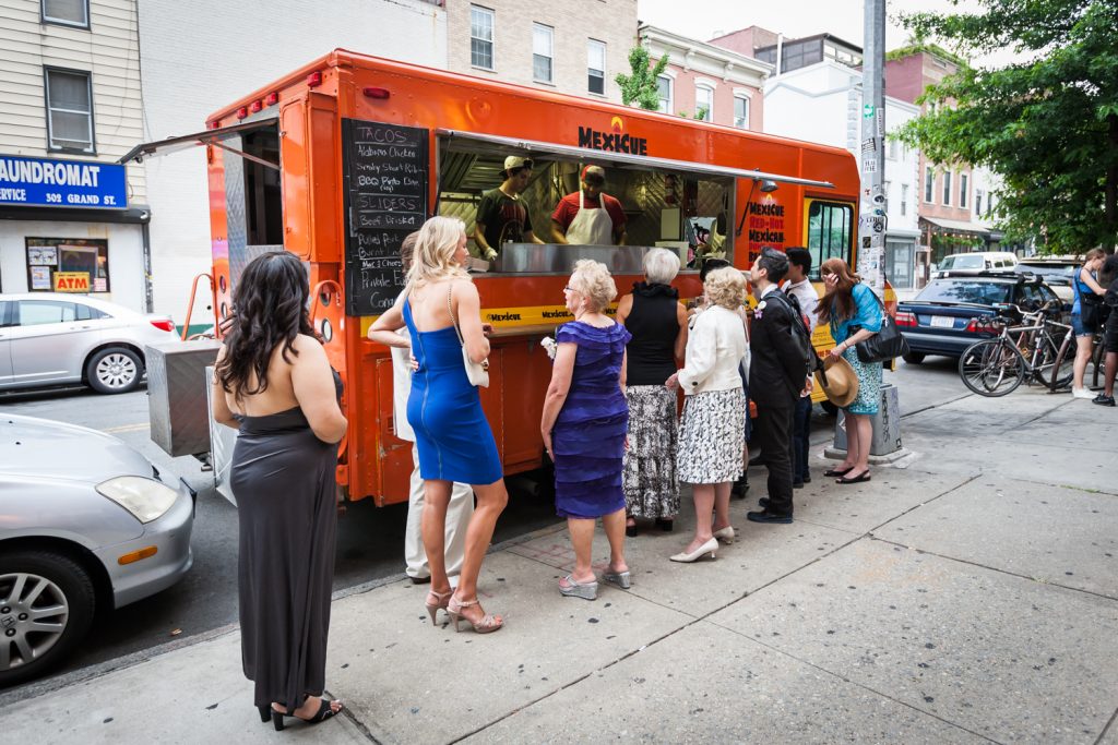 Guests lined up at food truck at a Brooklyn Bridge Park wedding