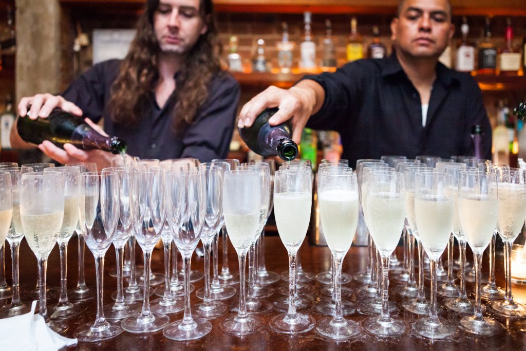 Bar staff pouring champagne during Williamsburg wedding reception