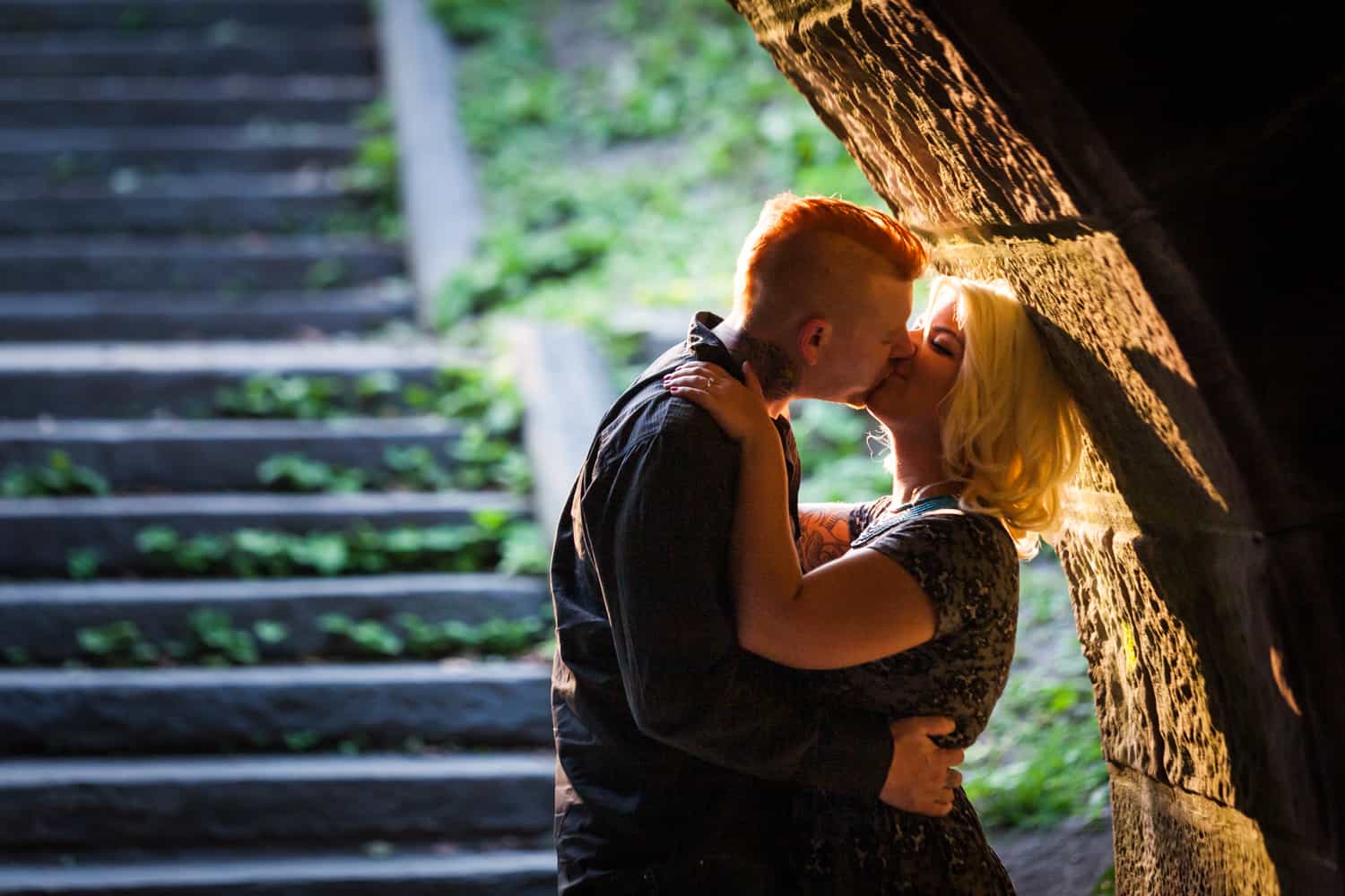 Central Park engagement photos of couple kissing under Trefoil Arch