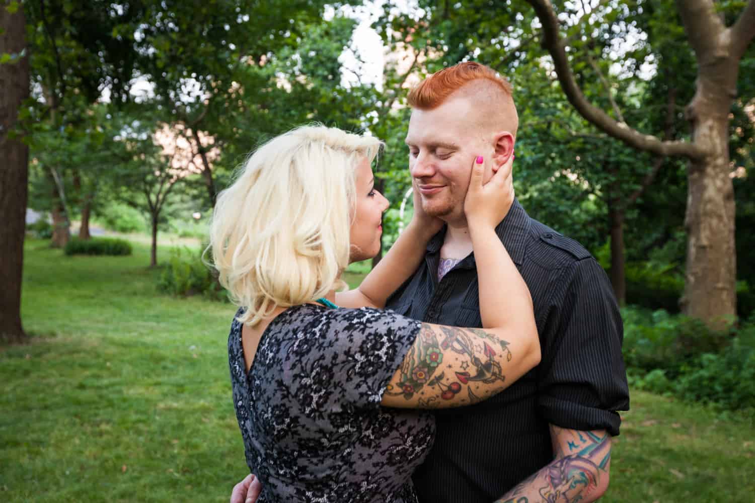 Central Park engagement photos of woman grabbing man's face