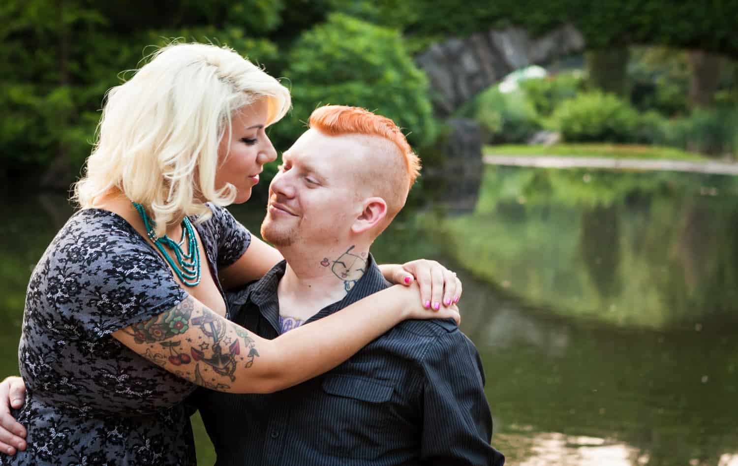 Central Park engagement photos of couple hugging in front of Gapstow Bridge