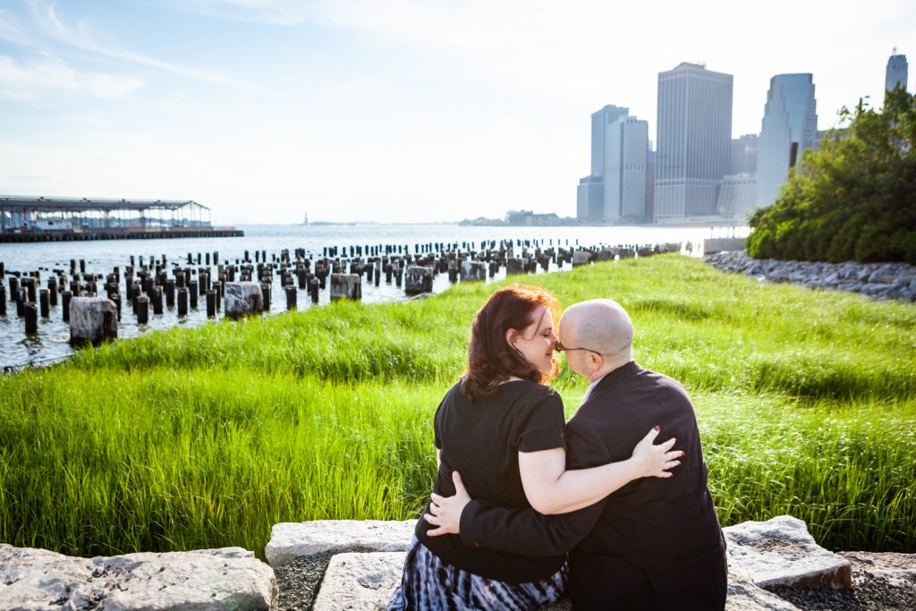 Couple kissing with abandoned dock poles in background 