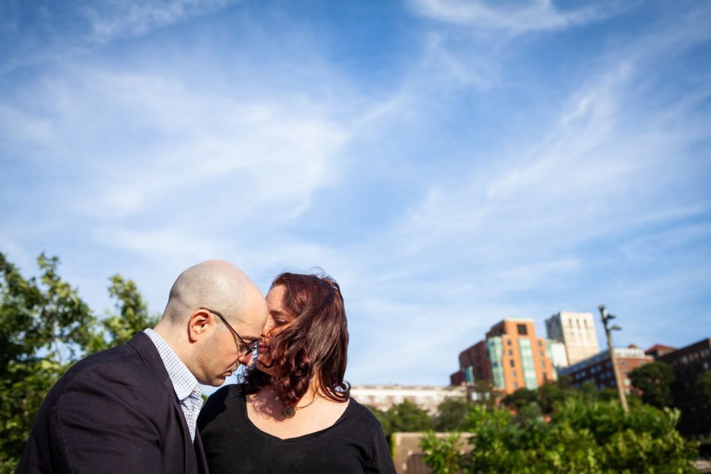 Couple against wide open sky during a Brooklyn Bridge Park engagement portrait session