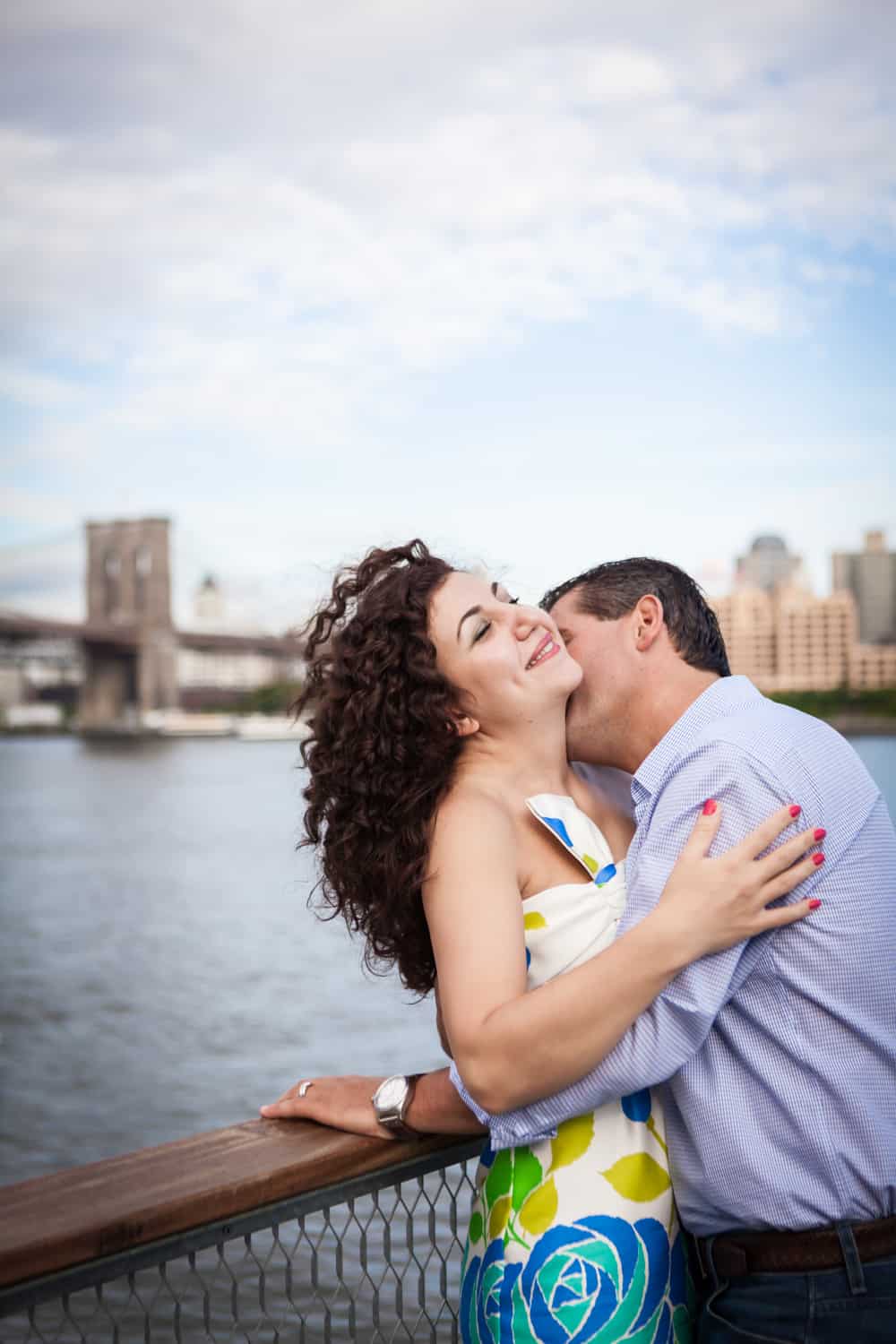 Financial District engagement photos of man kissing woman on the neck