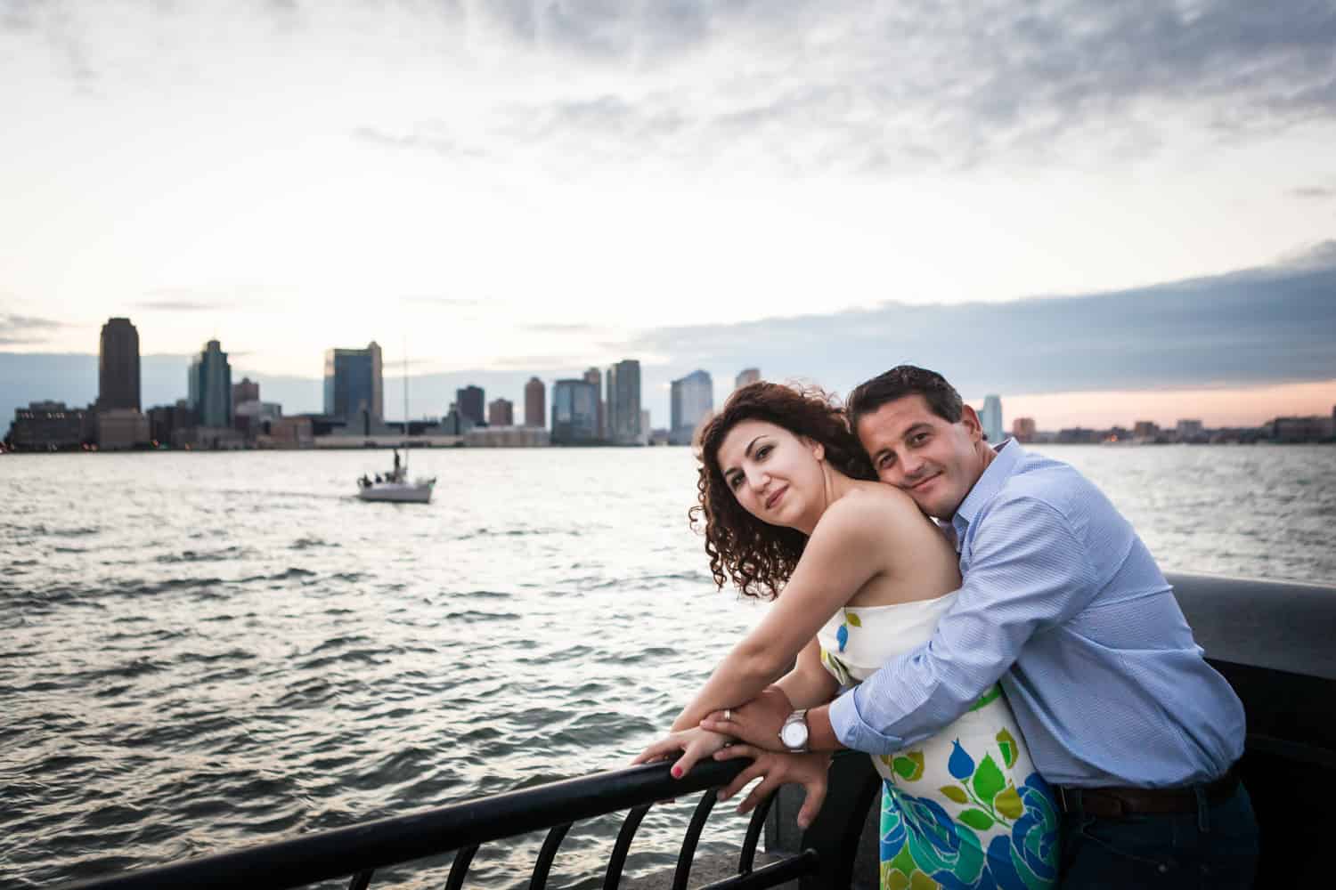 Couple hugging in front of NYC waterfront