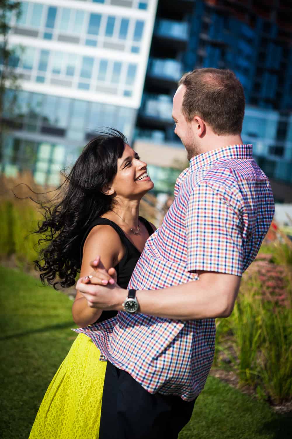 Couple dancing on boardwalk at a Gantry Plaza State Park engagement shoot