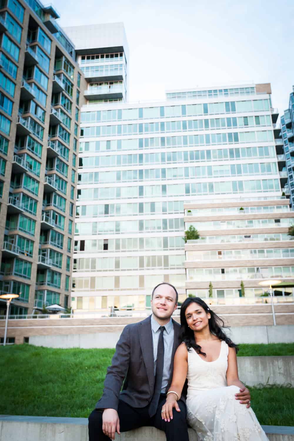 Couple in front of glass-front buildings in Long Island City