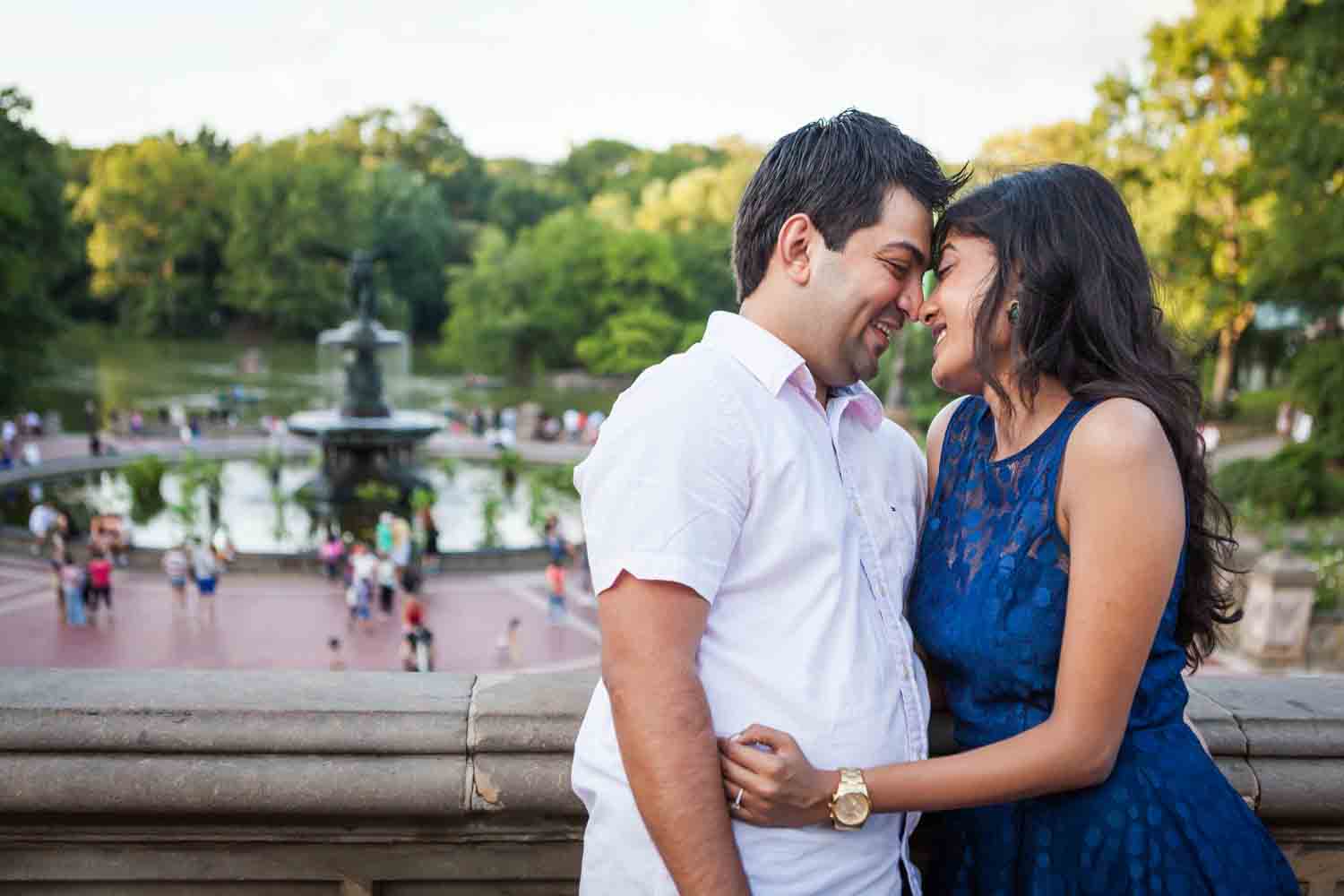 Couple hugging with Bethesda Fountain in the background
