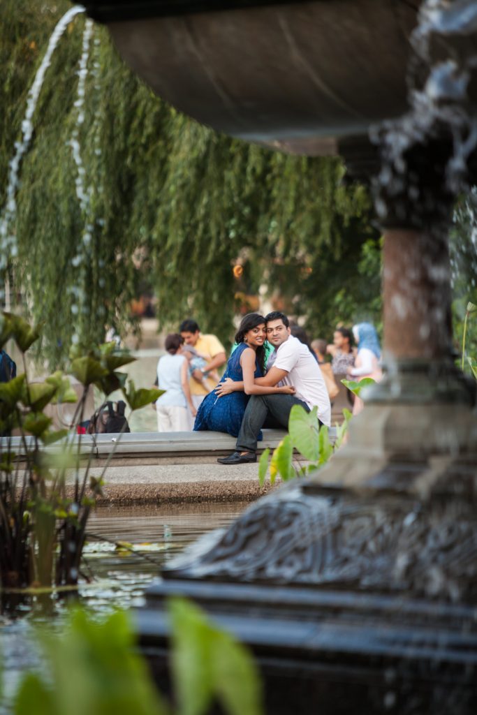 View of couple sitting on edge of Bethesda Fountain