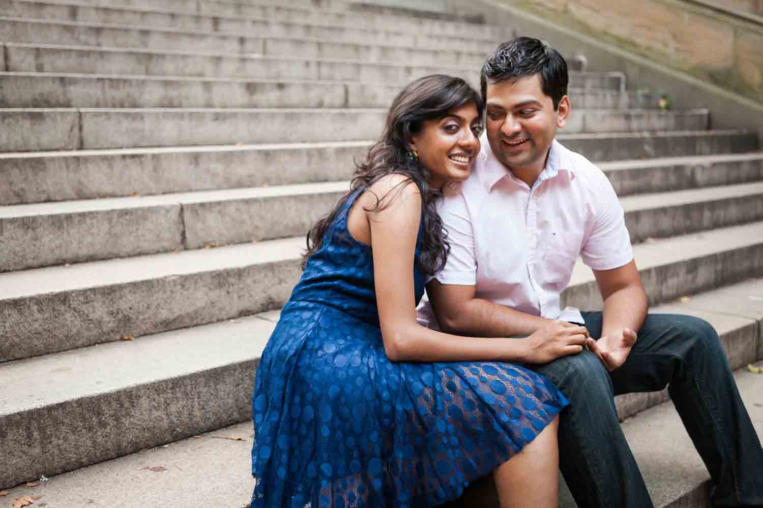 Couple sitting on steps during a Central Park engagement shoot