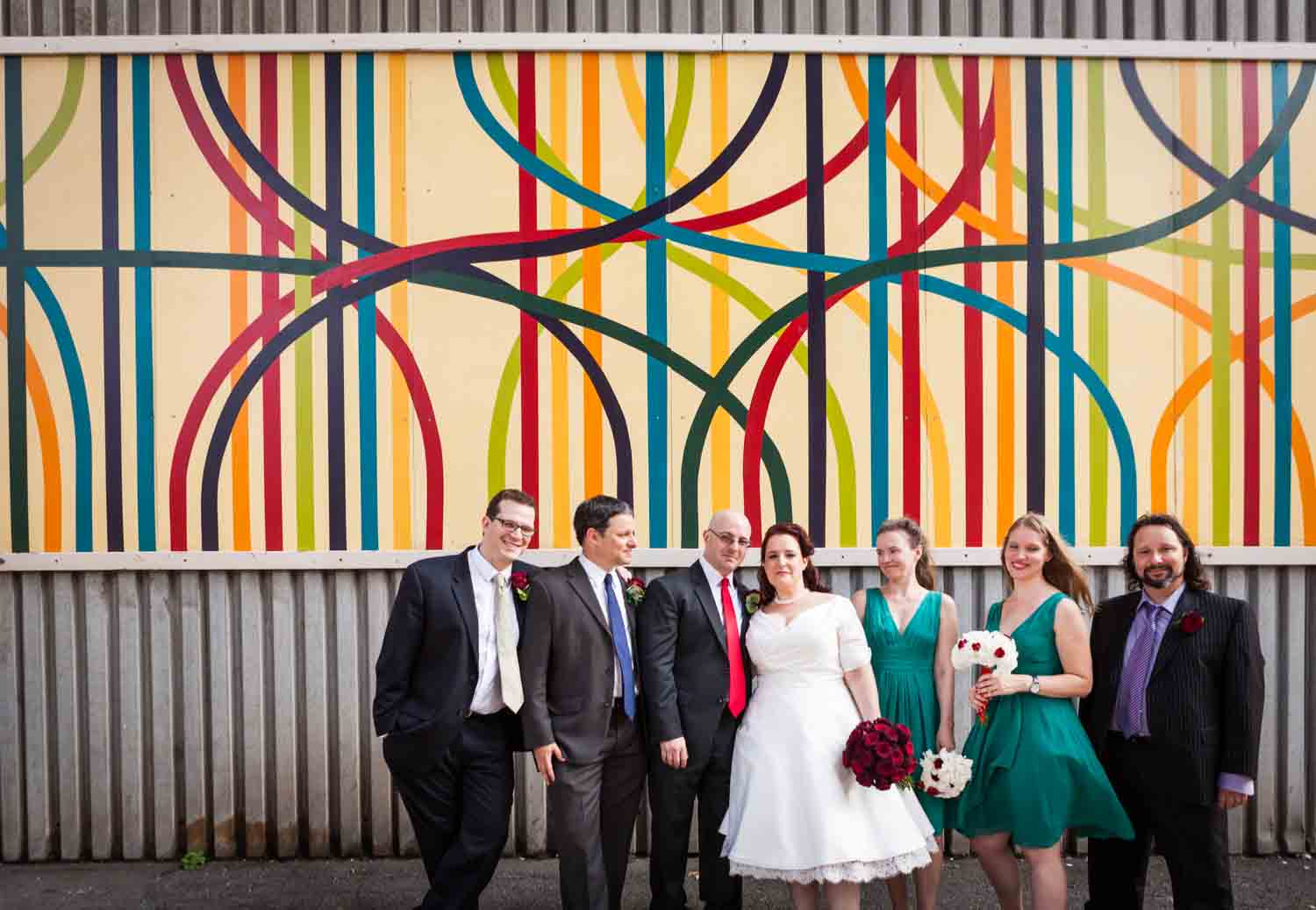 Bridal party standing in front of DUMBO mural