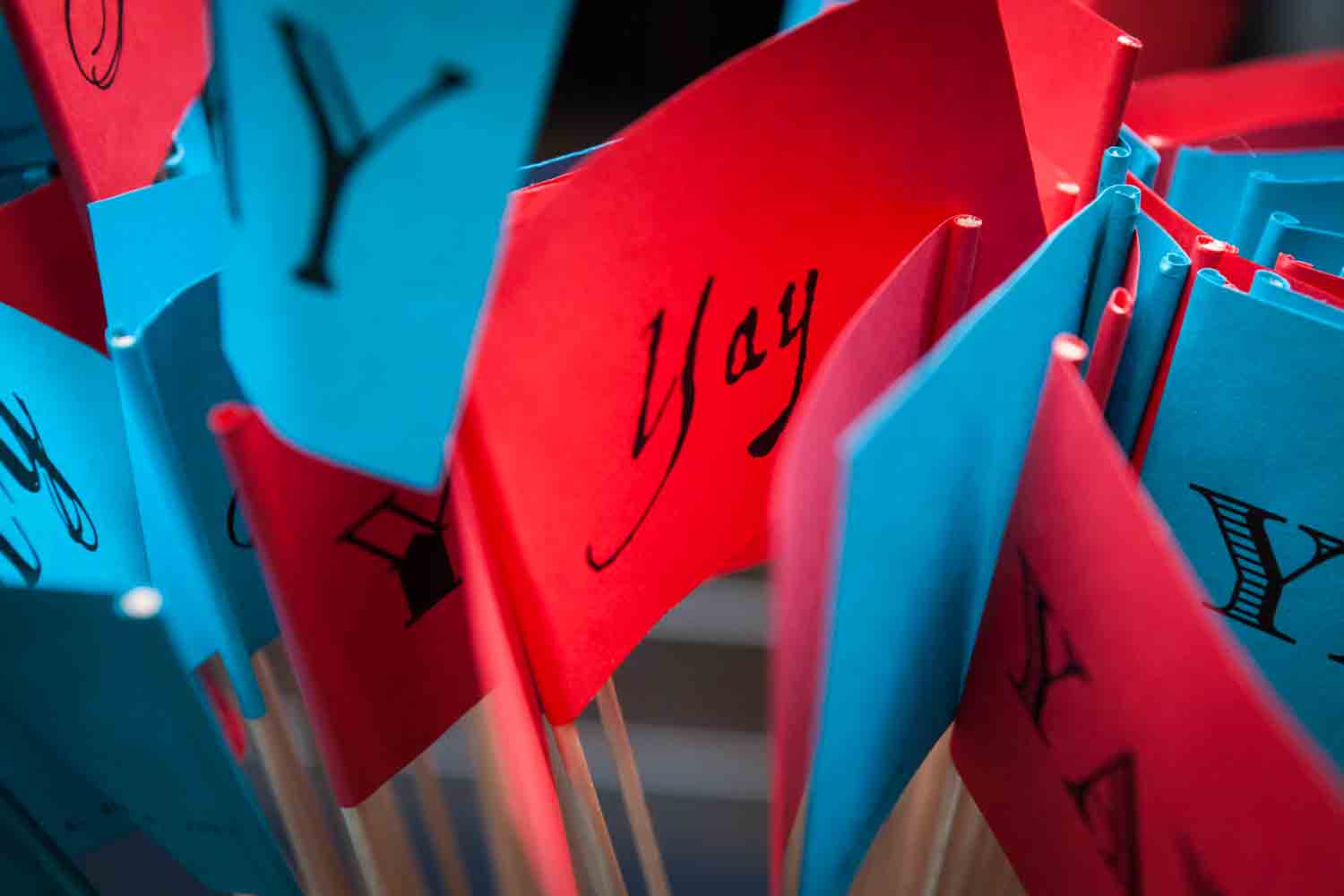 Close up on red and blue flags with the word 'Yay!'
