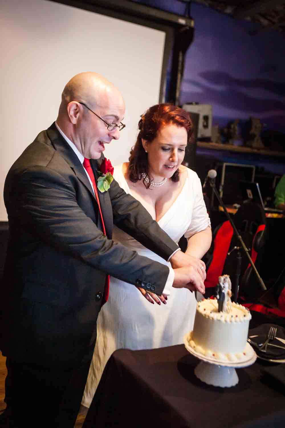 Bride and groom cutting cake at a DUMBO wedding