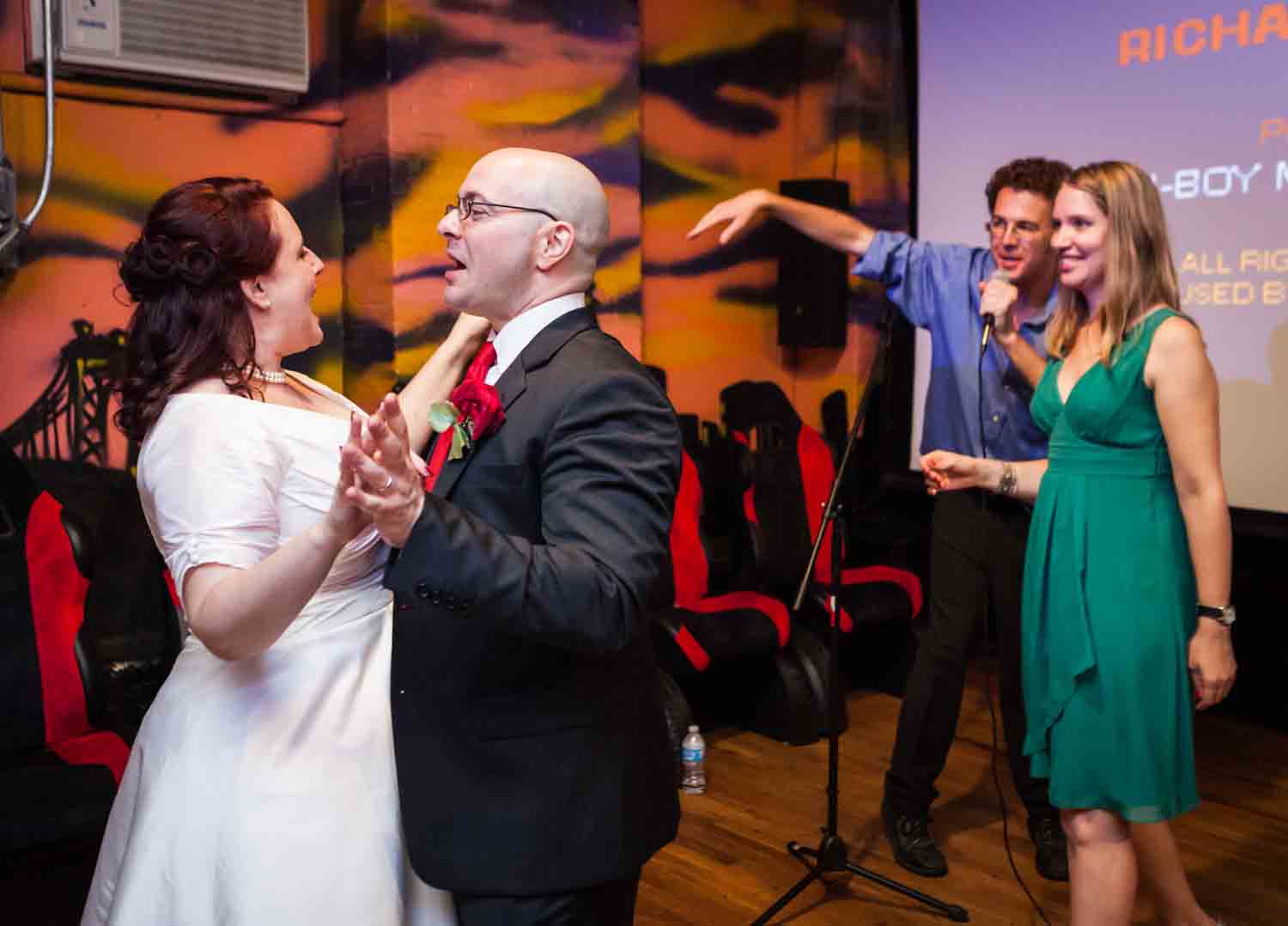 Bride and groom dancing with other couple to right 